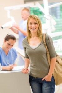 woman standing at front desk at dental office