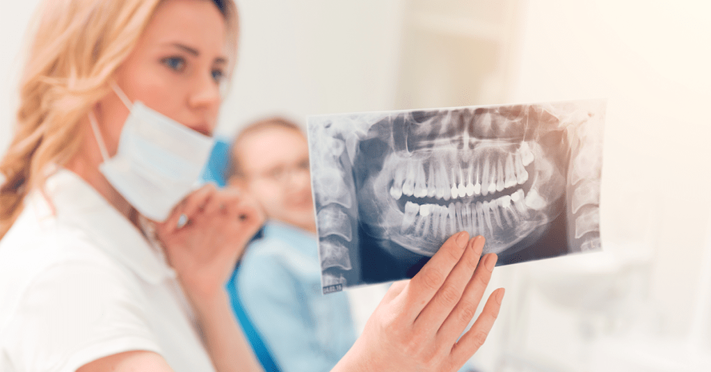 oral surgeon explaining procedure to patient